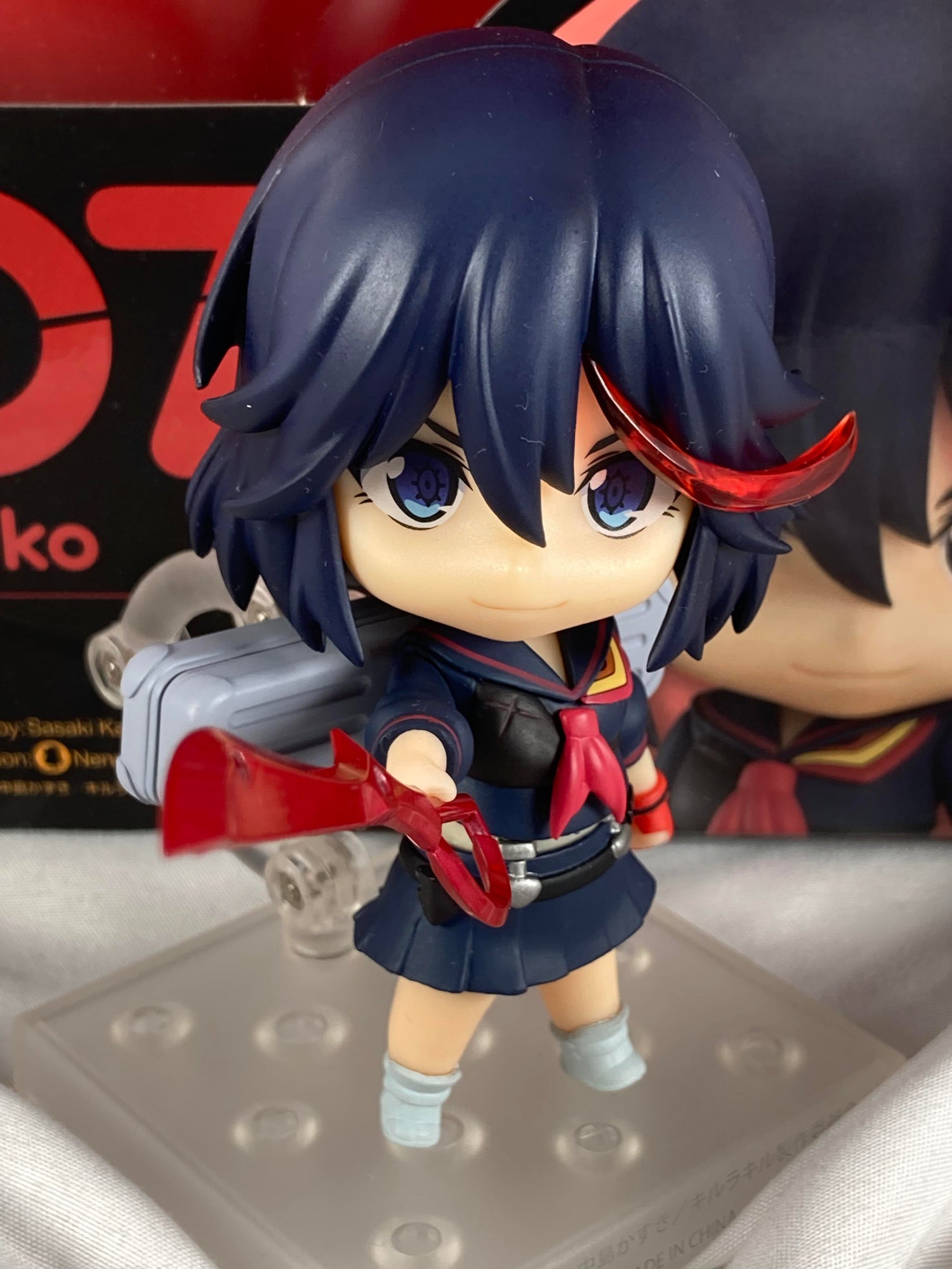 Matoi Ryuko nendoroid with her scissor blade pointing at you with a stern expression for the Kill la Kill collection page